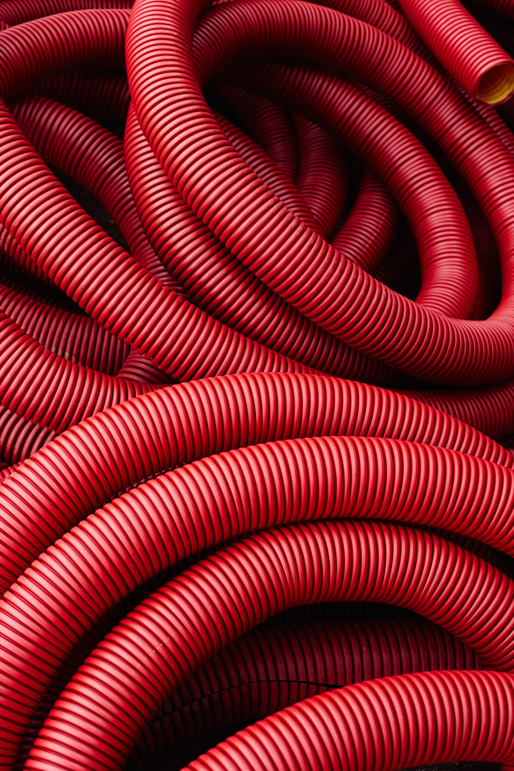 Industrial background - red plastic corrugated pipes
